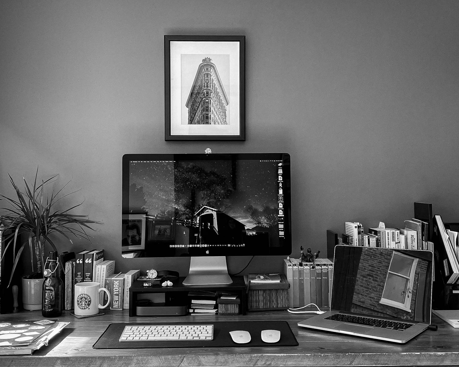 a desk with a computer and a laptop on it