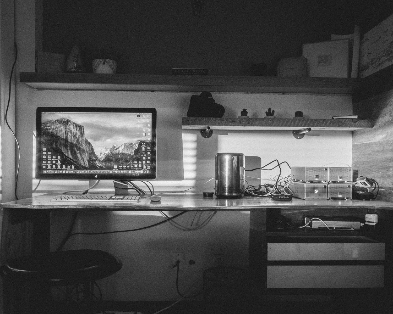 black flat screen computer monitor on desk inside dim-lit room