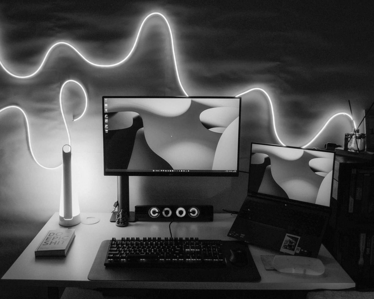 a desk with two monitors and a keyboard