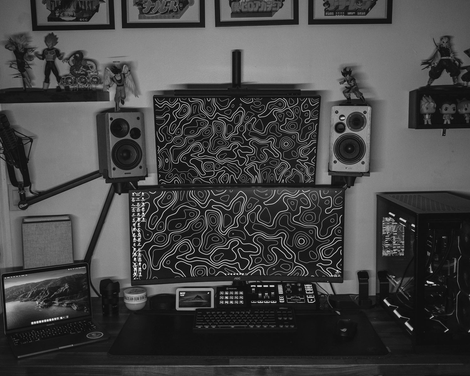 a computer desk with a laptop and speakers on it