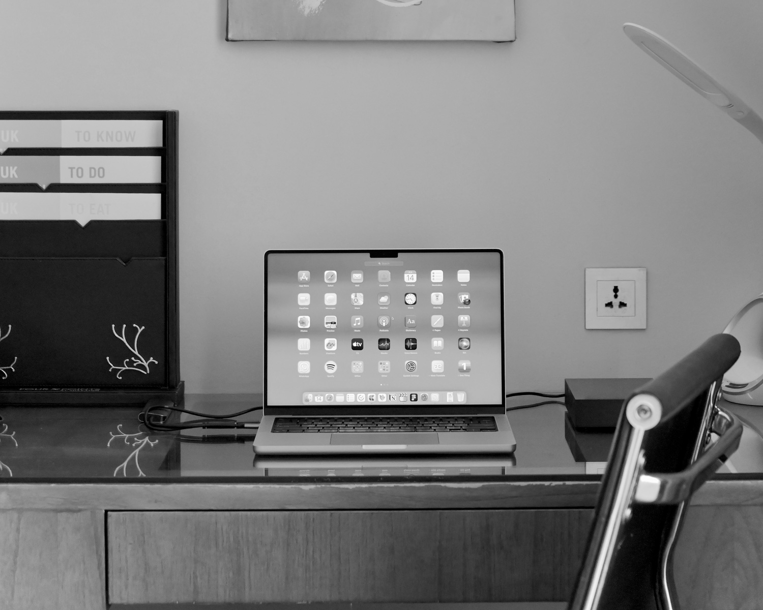 a laptop computer sitting on top of a wooden desk