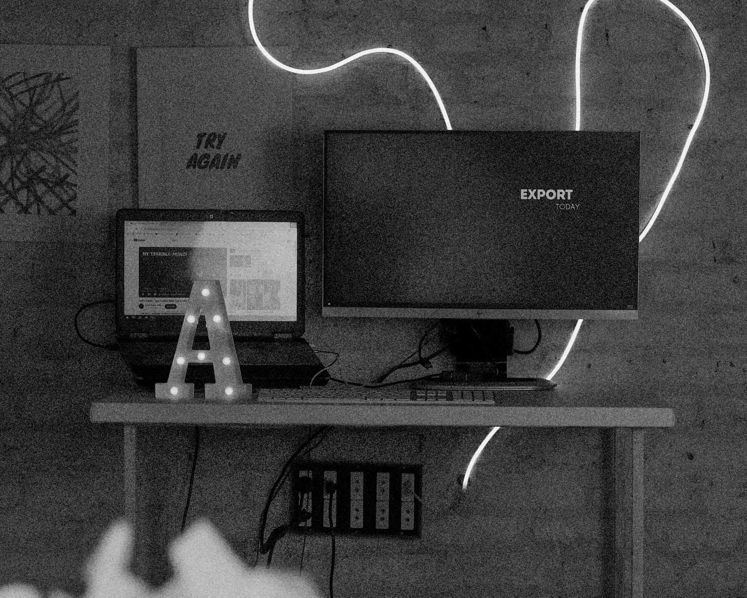 A desk with a computer monitor and keyboard on it