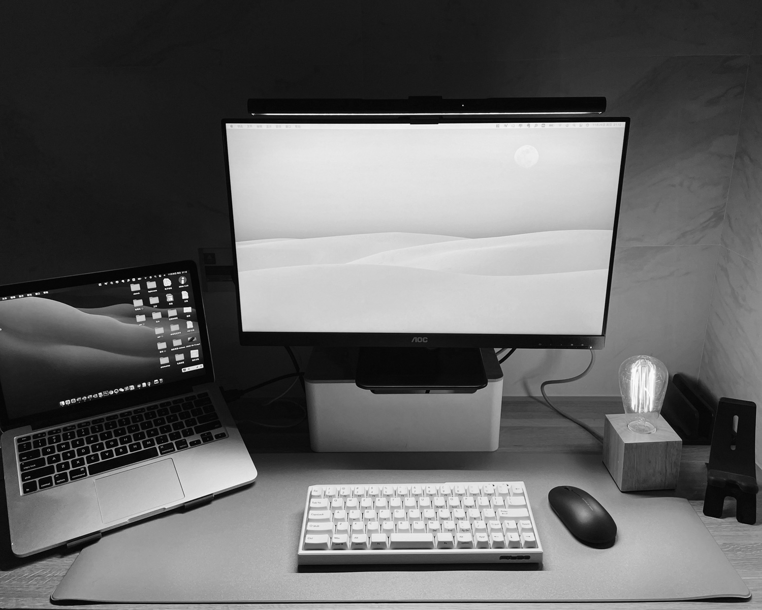 a desk with a laptop and a computer monitor