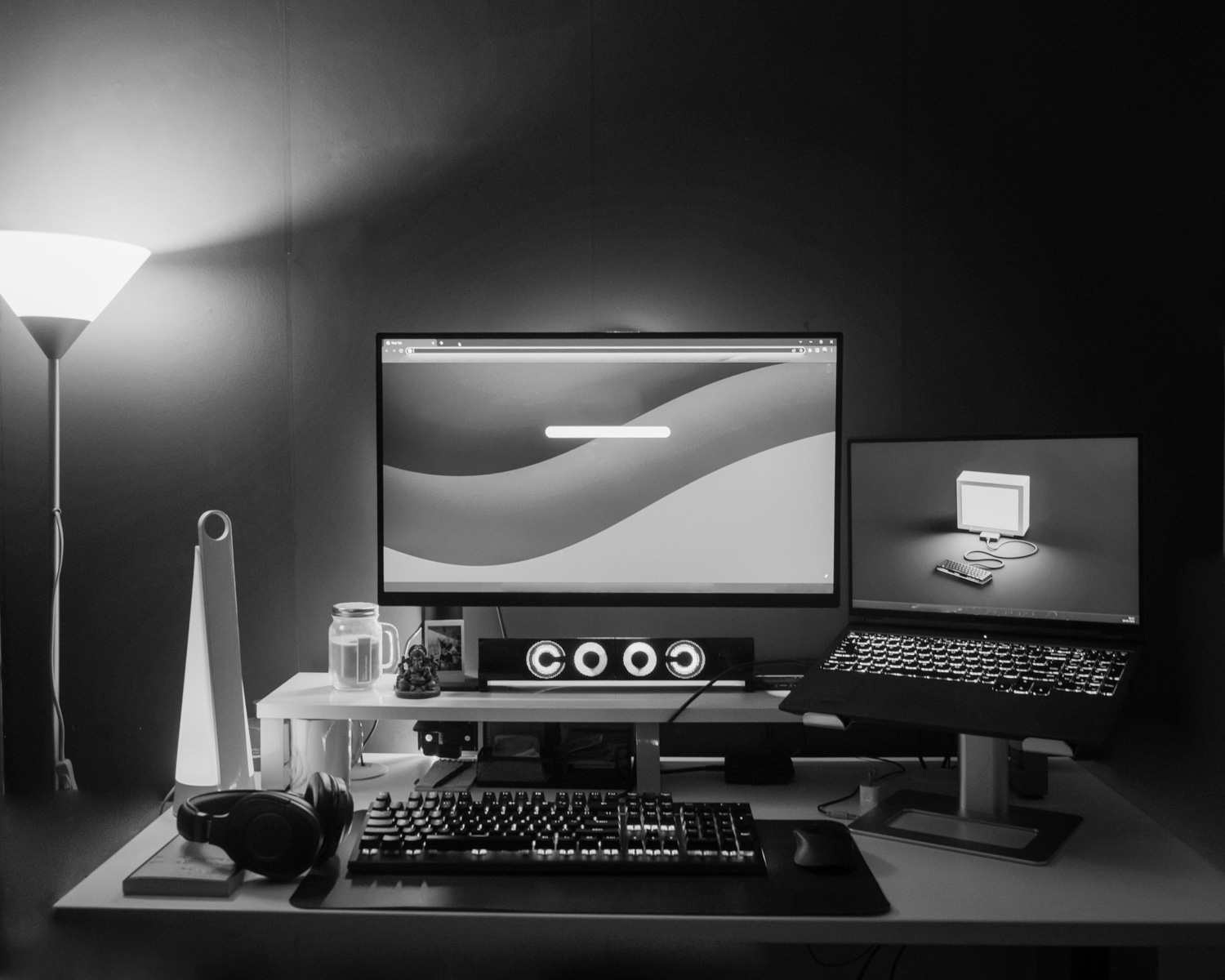 a desk with two monitors and a keyboard
