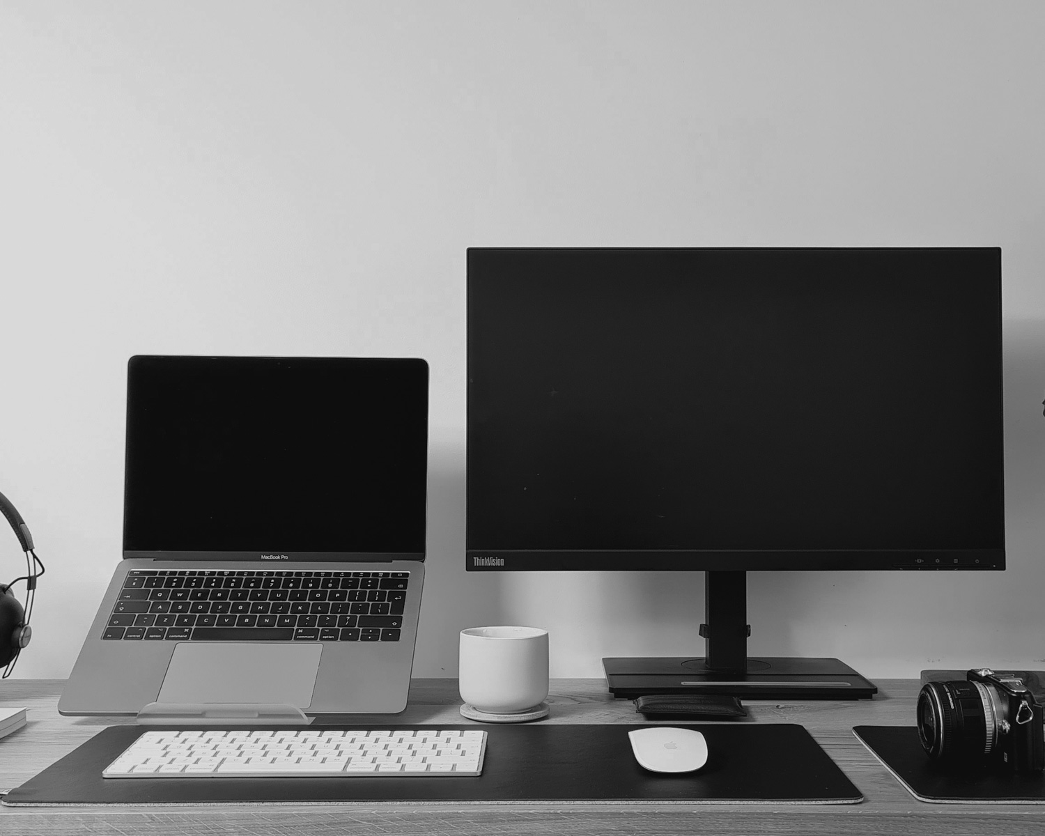 black flat screen computer monitor on brown wooden desk